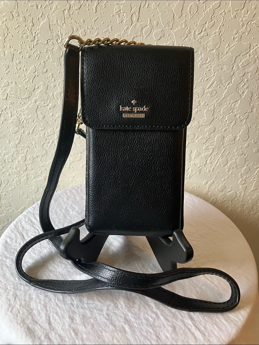 kate spade: Black Pebbled Leather North/South Crossbody Phone Holder- Gold Tone